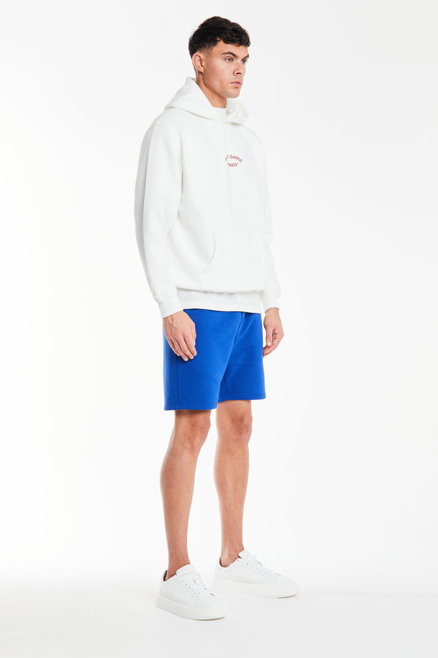 White men's hoodie with cuffed sleeves styled with shorts