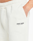 close up of 'Avant Garde Paris' logo on off white jersey shorts