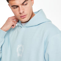 Close up of mens coord set hoodie in baby blue with logo on chest