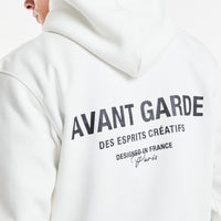 close up of the back of men's hoodies in ecru with 'Avant Garde' logo on back