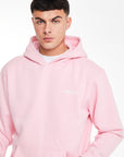 close up of men's hoodies in pink with 'avant garde' logo on chest