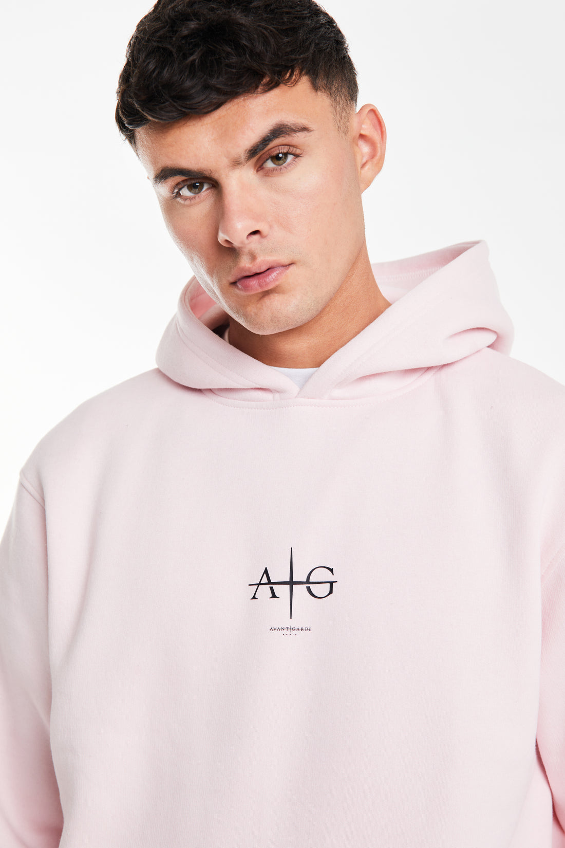 close up of 'Avant Garde' logo on chest of a pink coord for men