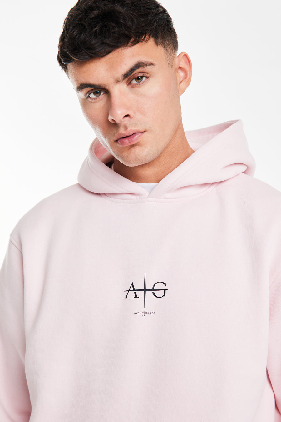 close up of 'Avant Garde' logo on chest of a pink coord for men