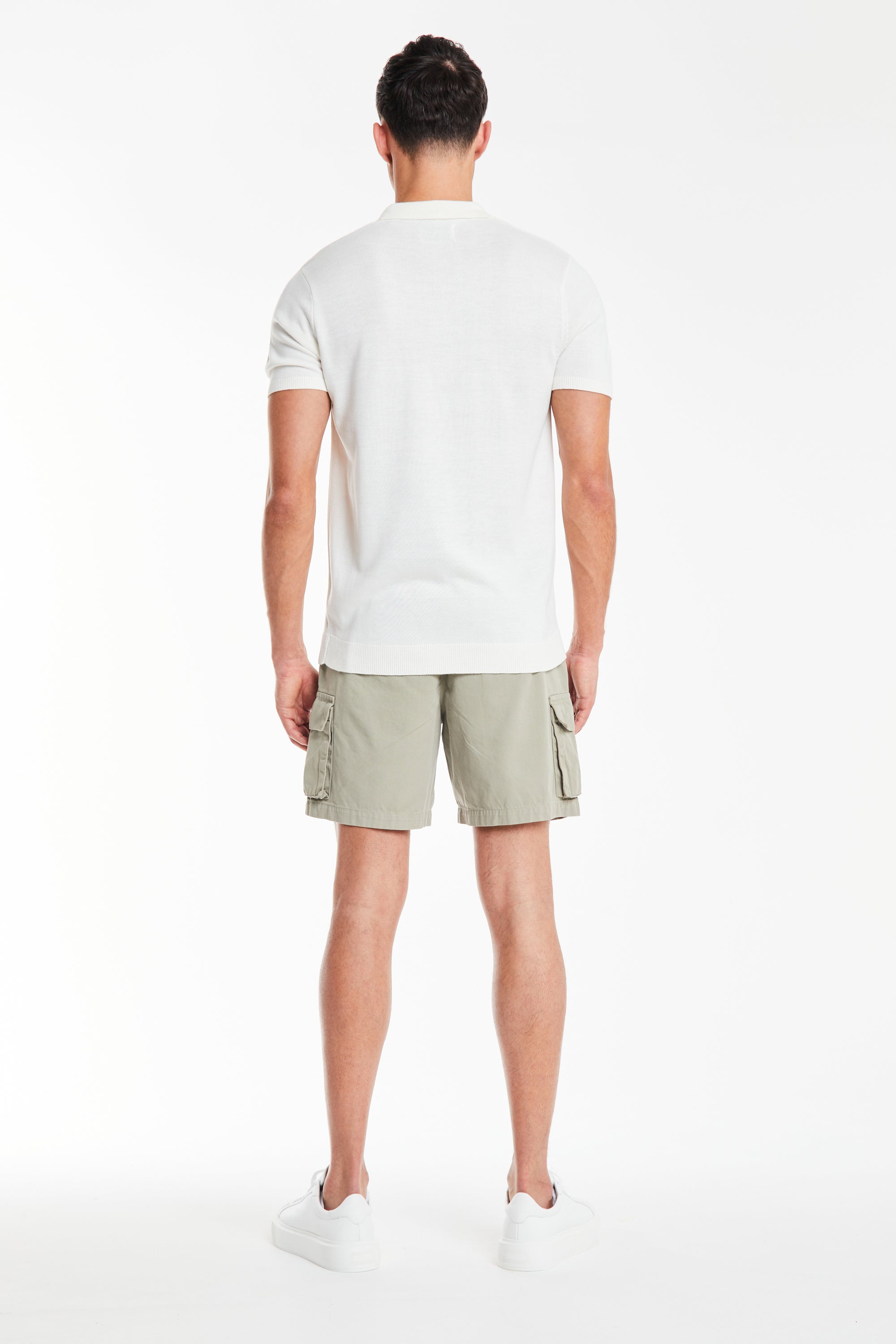 back profile of men&#39;s utility shorts with pockets in sage