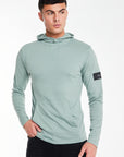 Model wearing a 'Collusive' plain hoodies for men in mint green