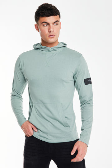 Model wearing a 'Collusive' plain hoodies for men in mint green