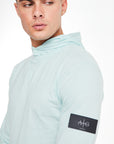 Close up of 'Avant Garde Paris' logo on a cheap mens hoodie in light blue