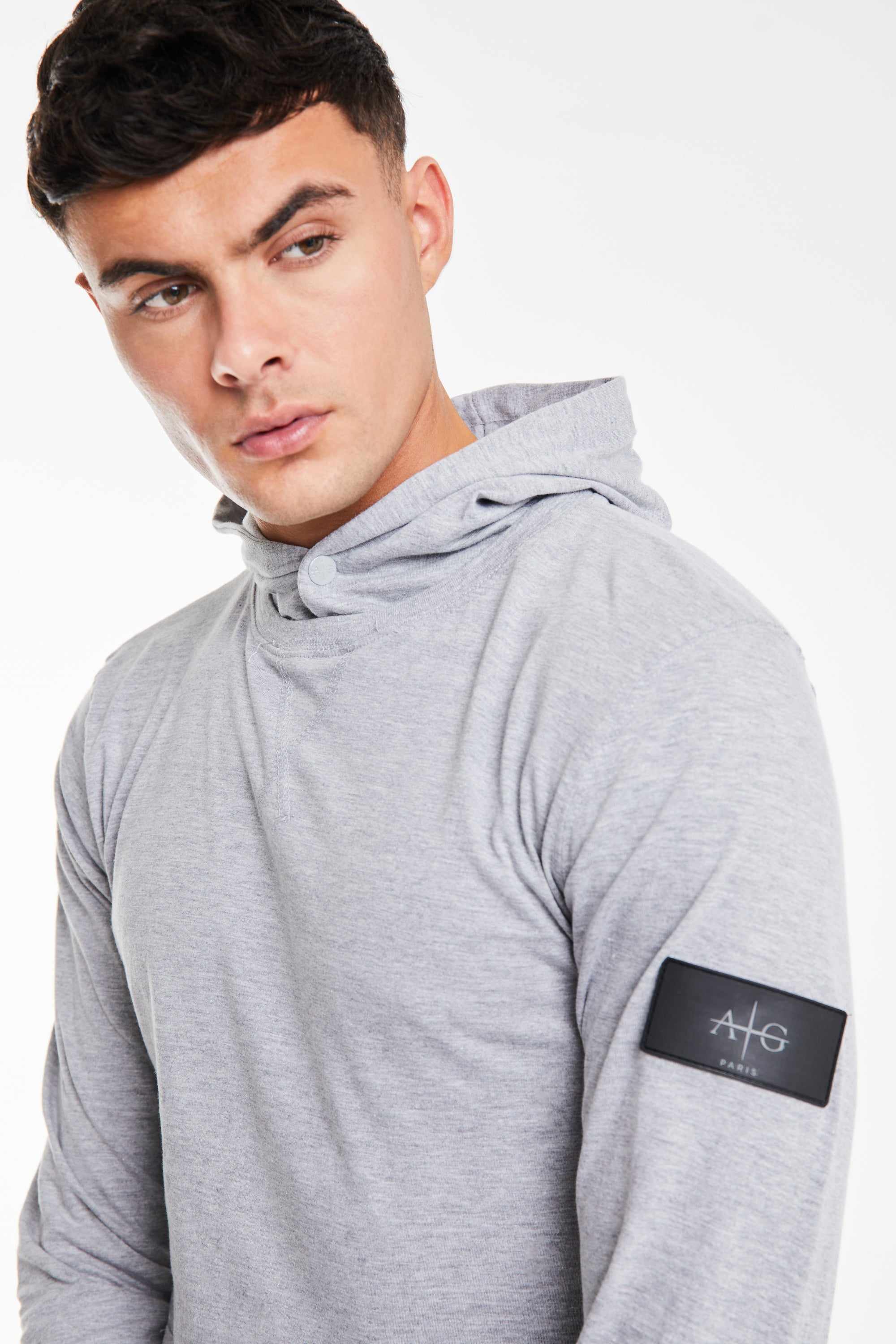 close up of 'Avant Garde Paris' logo on plain hoodies in light grey