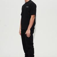 model wearing black oversized tee and joggers