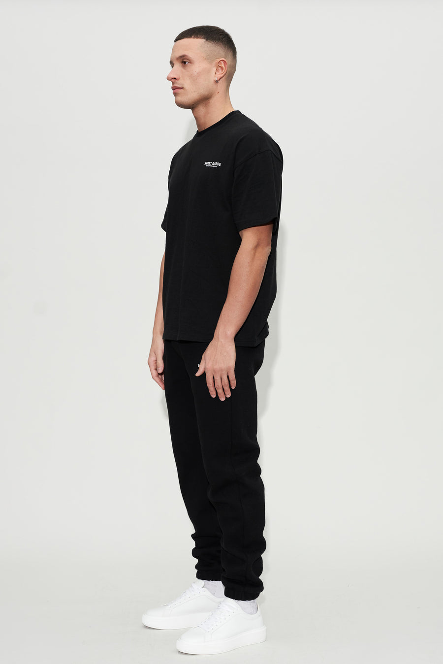 model wearing black oversized tee and joggers