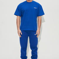 Model wearing blue t-shirt and joggers