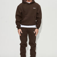 Model wearing creatives hoodie and joggers in chocolate